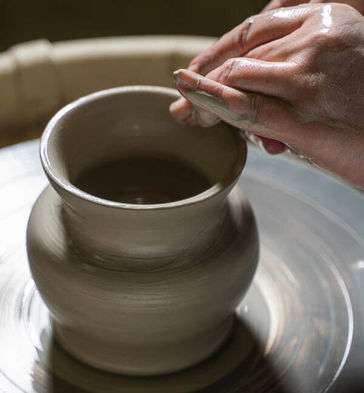 Student Sculpts a Vase on a Spinning Wheel