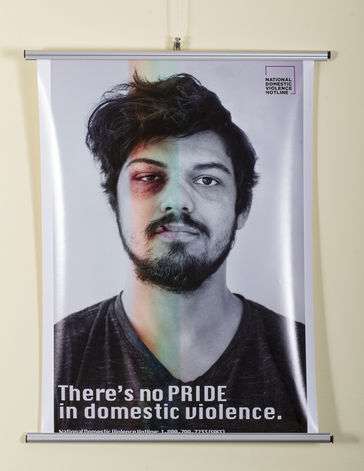 A man facing the front with a black eye and rainbow overlaying it. It says There's no Pride in Domestic Violence