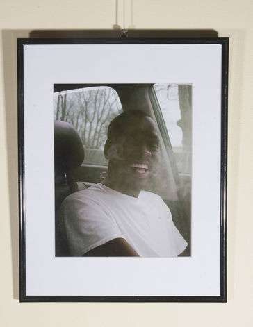 Man with mouth open in laughter exhailing smoke at the same time. 