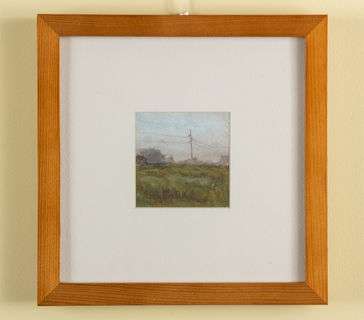 A field on a misty day with powerlines. 