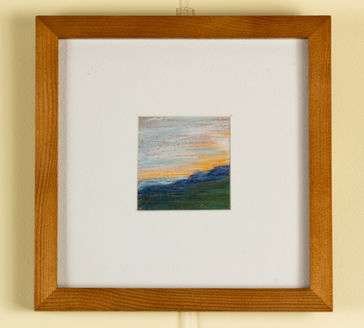 A sunrise emerging over a cliff. 