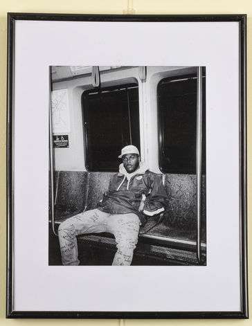 A young brother sitting on a train, expressing his self through his pouts and expressions