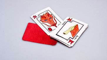 An assortment of playing cards decorated with Japanese Kanji and figures in traditional clothing